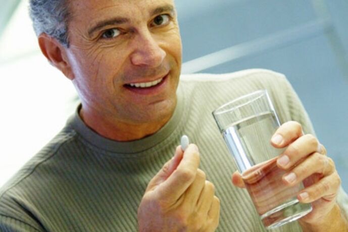 A man takes a pill to treat prostatitis
